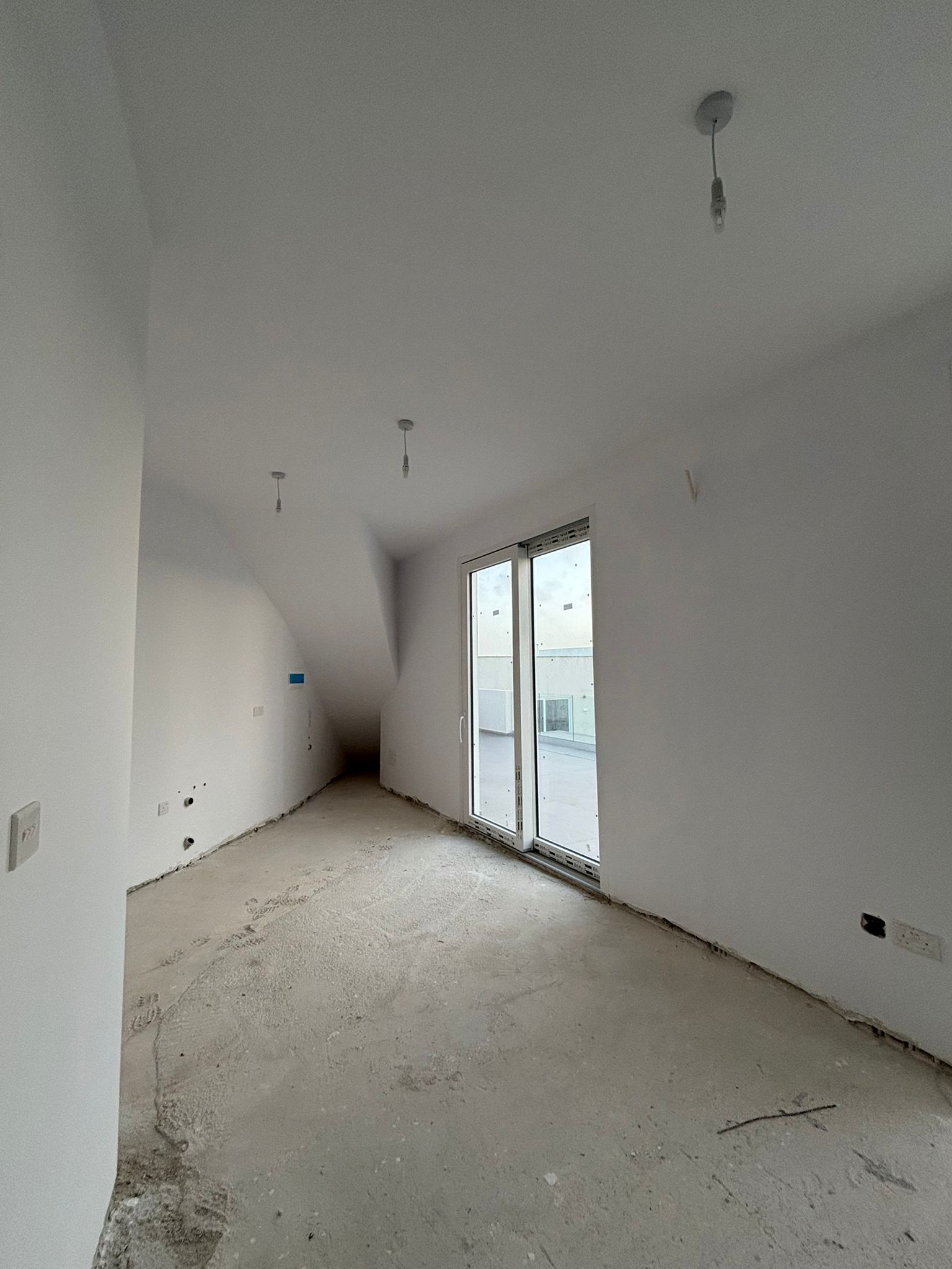 Living room with balcony doors at the GO07 penthouse